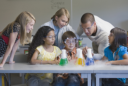 Children (10-11) and teacher at science class